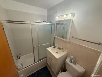 a bathroom with sink shower and mirror