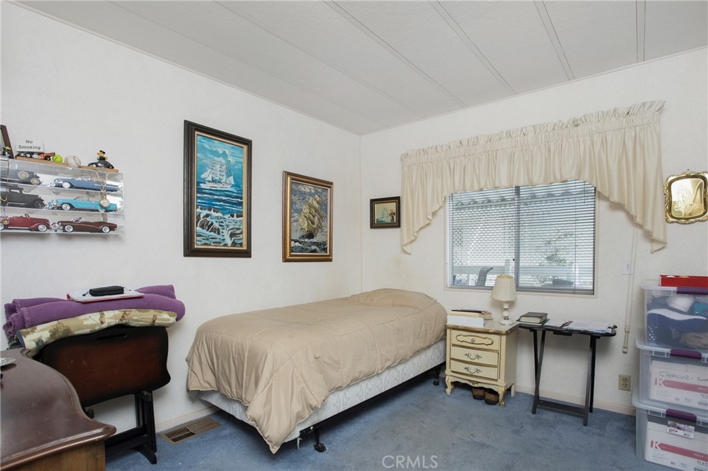 692 North Adele Street, Unit 49 Orange, CA 92867 - Photo 11 of 16 a bedroom with a bed and a table in it