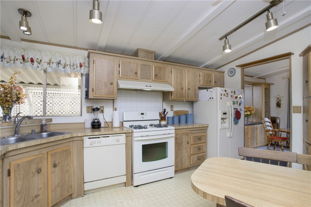 692 North Adele Street, Unit 49 Orange, CA 92867 - Photo 7 of 16 a kitchen with stainless steel appliances a stove sink refrigerator and cabinets