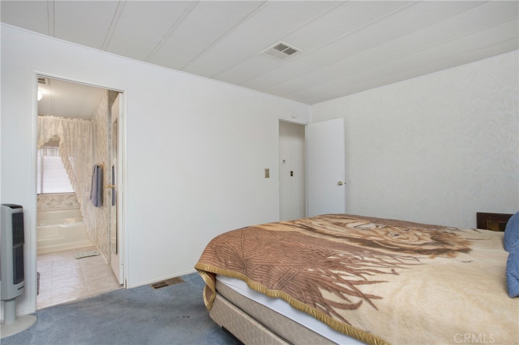 692 North Adele Street, Unit 49 Orange, CA 92867 - Photo 9 of 16 a bedroom with a bed and a view of bathroom
