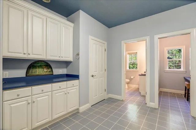 a workspace with lounge chair and a window