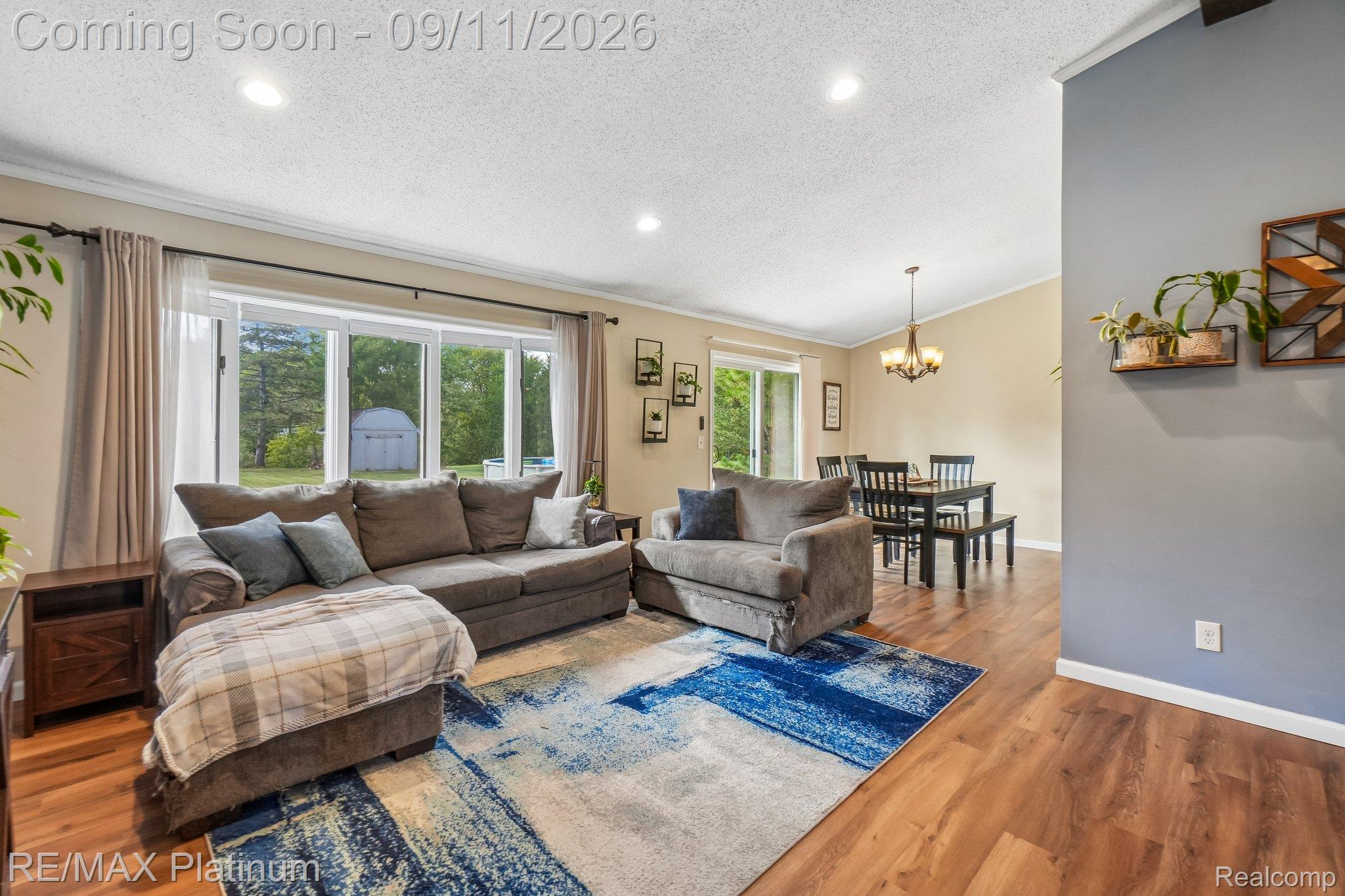 12126 Linden Road Linden, MI 48451 - Photo 6 of 38 Recessed lighting, LVP flooring, and a sliding glass door to the exterior