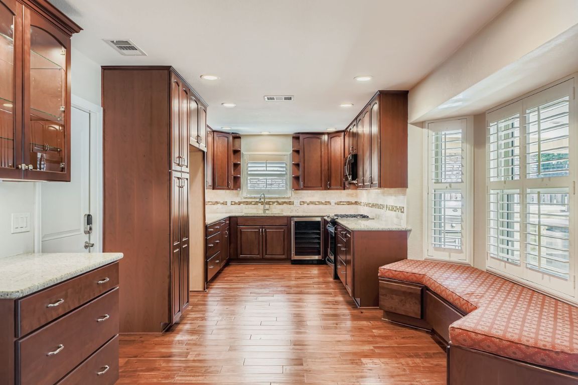 7202 Beckett Road Austin, TX 78749 - Photo 10 of 28 a large kitchen with a large counter top space a sink stainless steel appliances and cabinets