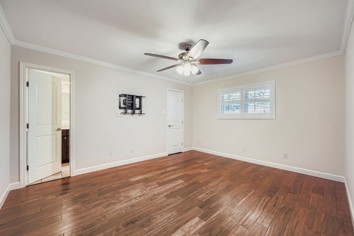 7202 Beckett Road Austin, TX 78749 - Photo 12 of 28 wooden floor in an empty room with a window