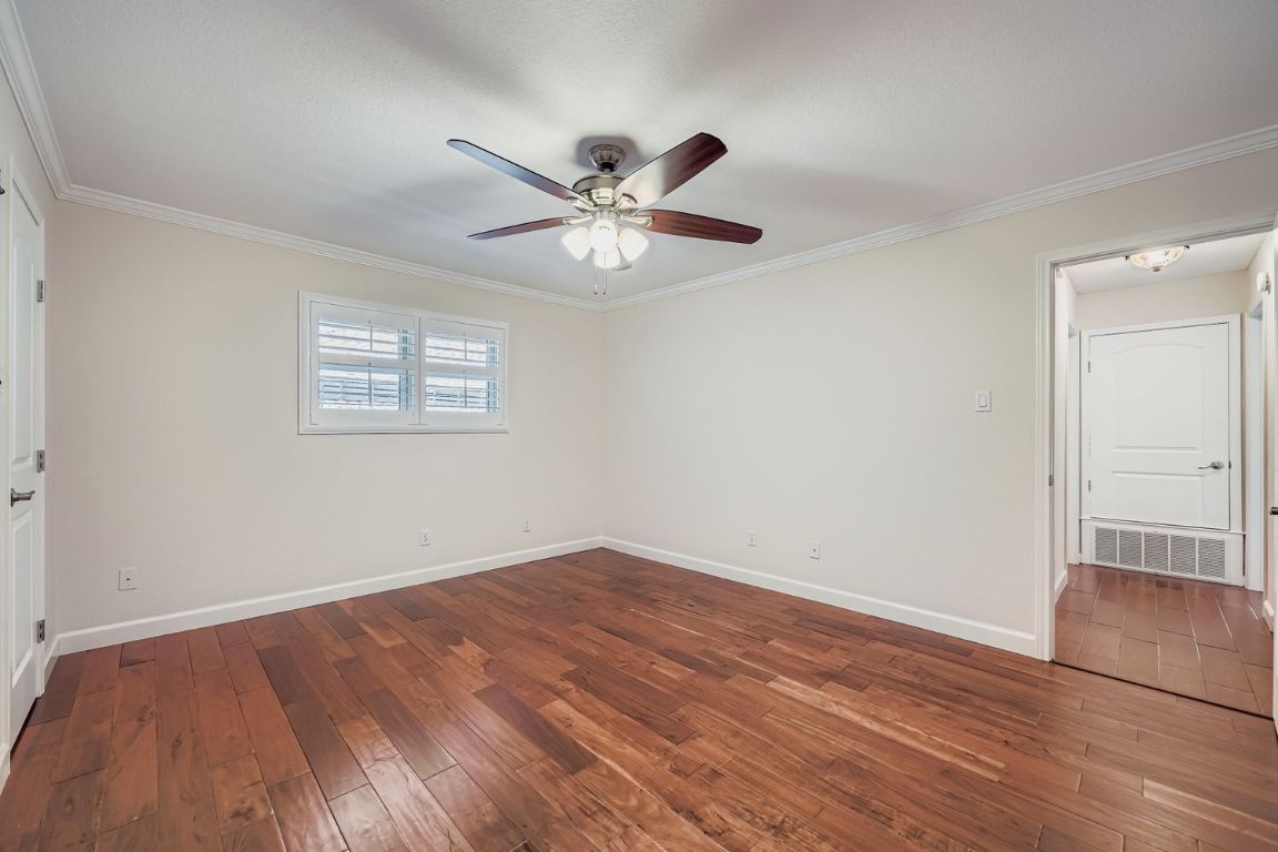 7202 Beckett Road Austin, TX 78749 - Photo 15 of 28 an empty room with wooden floor fan and windows