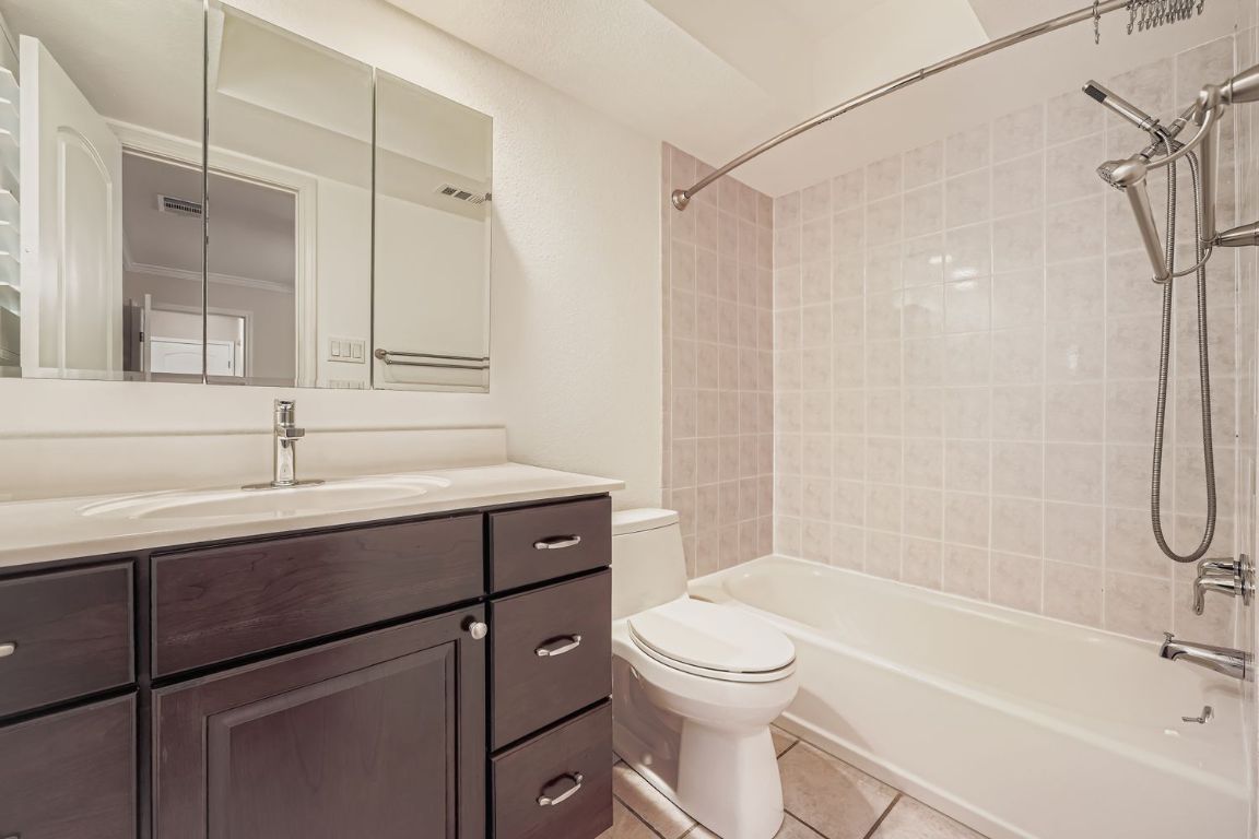 7202 Beckett Road Austin, TX 78749 - Photo 16 of 28 a bathroom with a sink a toilet and shower