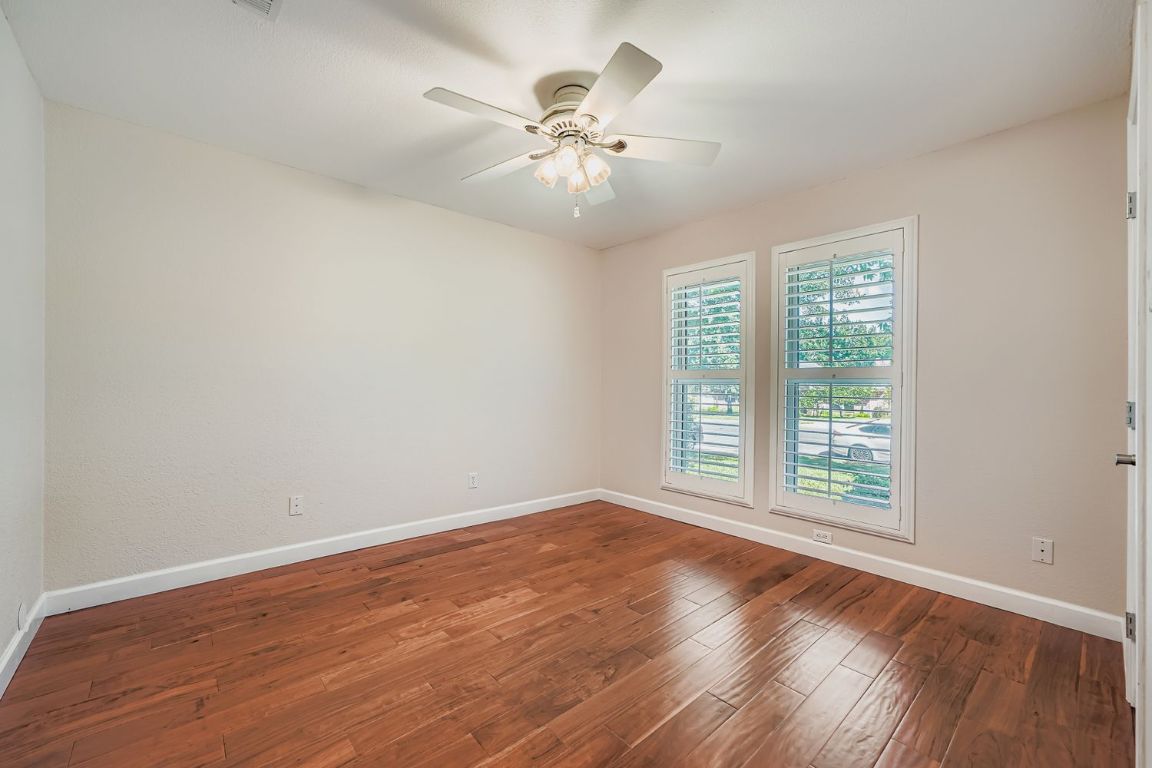 7202 Beckett Road Austin, TX 78749 - Photo 18 of 28 wooden floor in an empty room with a window