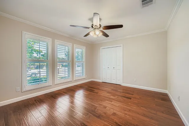 wooden floor in an empty room with a window