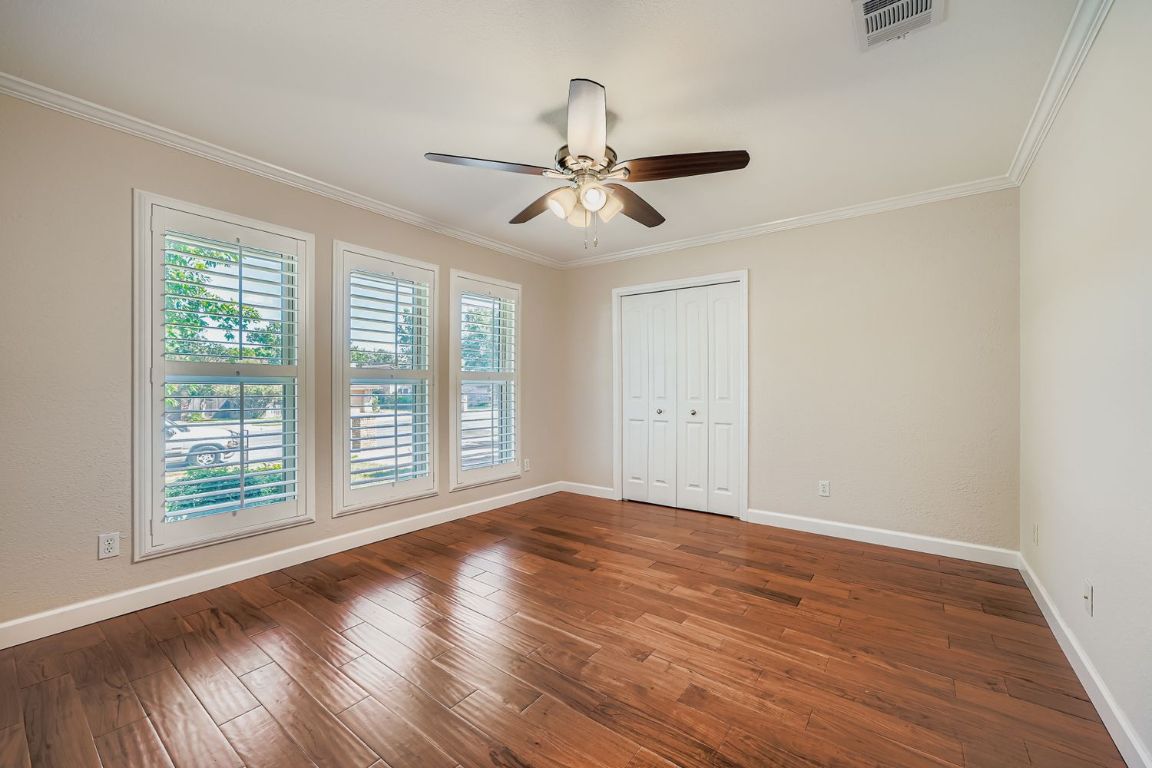 7202 Beckett Road Austin, TX 78749 - Photo 19 of 28 a view of empty room with wooden floor and fan