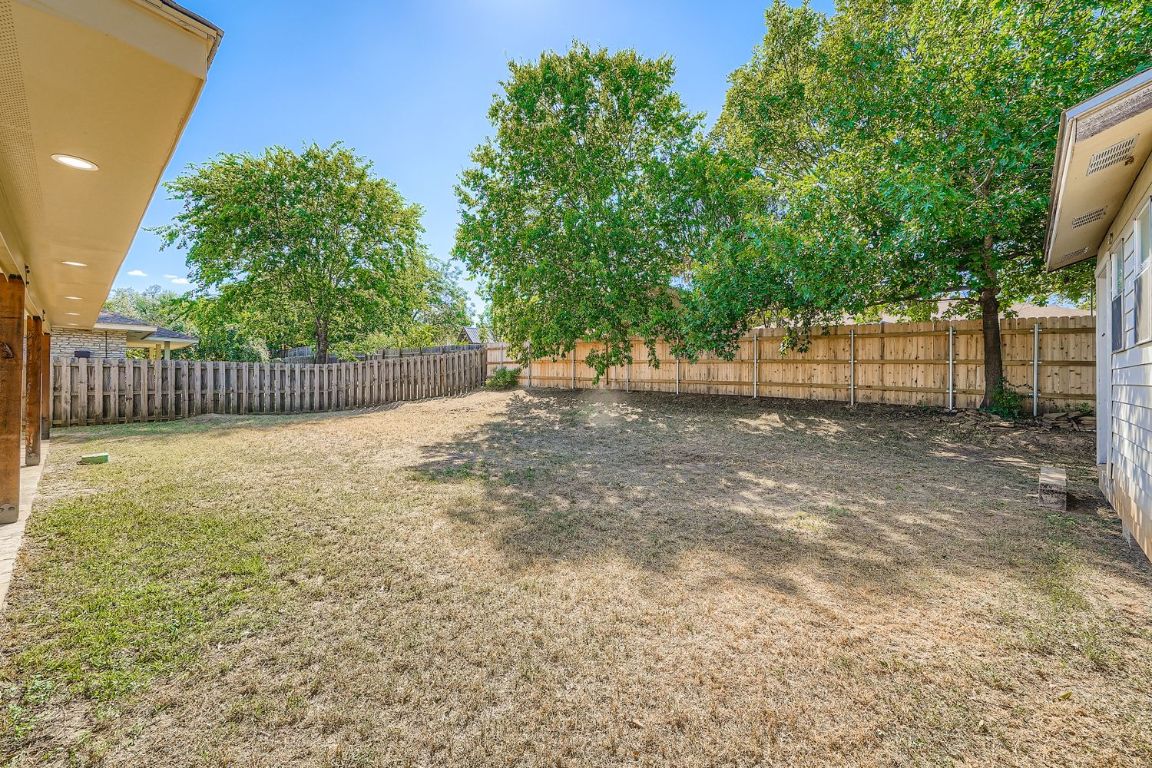 7202 Beckett Road Austin, TX 78749 - Photo 27 of 28 a view of backyard with tree and wooden fence