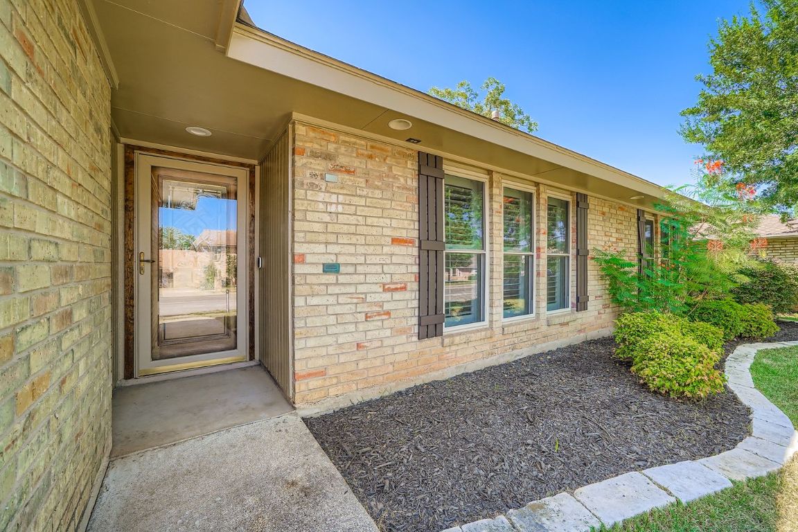 7202 Beckett Road Austin, TX 78749 - Photo 4 of 28 a view of a brick house with a large window