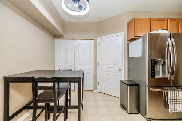 a kitchen with stainless steel appliances granite countertop a refrigerator a stove and a sink with wooden floor
