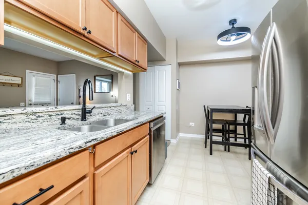 a kitchen with stainless steel appliances granite countertop a sink and cabinets