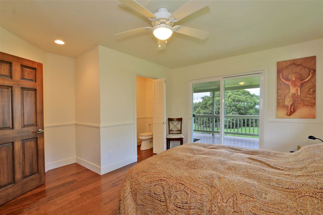 1855 B Kauhikoa Road Haiku, HI 96708 - Photo 20 of 30 a bedroom with a bed and a chandelier