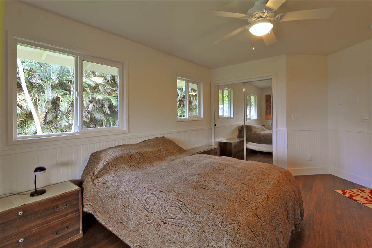 1855 B Kauhikoa Road Haiku, HI 96708 - Photo 21 of 30 a bedroom with a bed and a large window