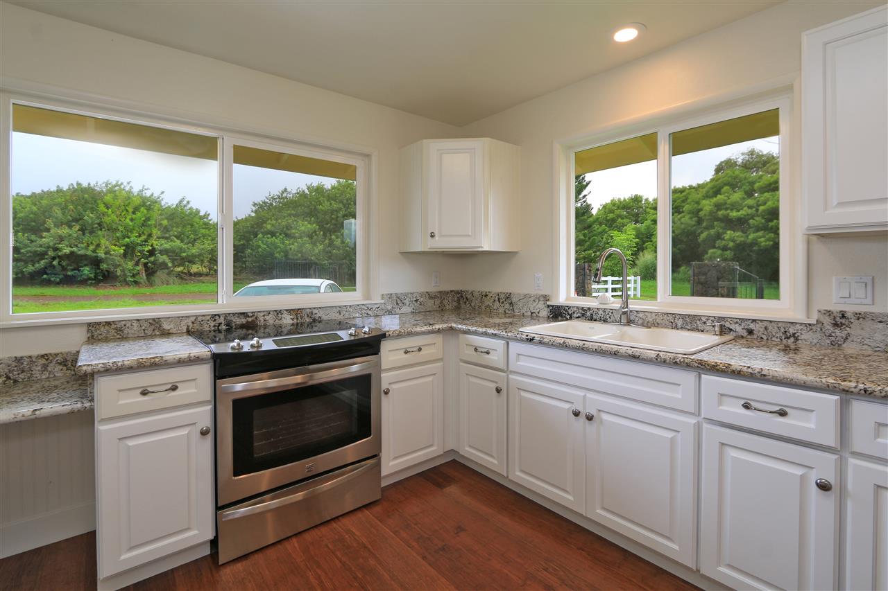 1855 B Kauhikoa Road Haiku, HI 96708 - Photo 4 of 30 a kitchen with a stove a sink and a large window