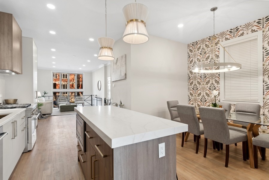 2139 West Crystal Street, Unit 1 Chicago, IL 60622 - Photo 11 of 27 a large kitchen with a table and chairs