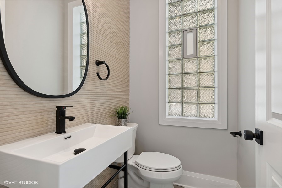 2139 West Crystal Street, Unit 1 Chicago, IL 60622 - Photo 12 of 27 a bathroom with a sink a toilet and a mirror