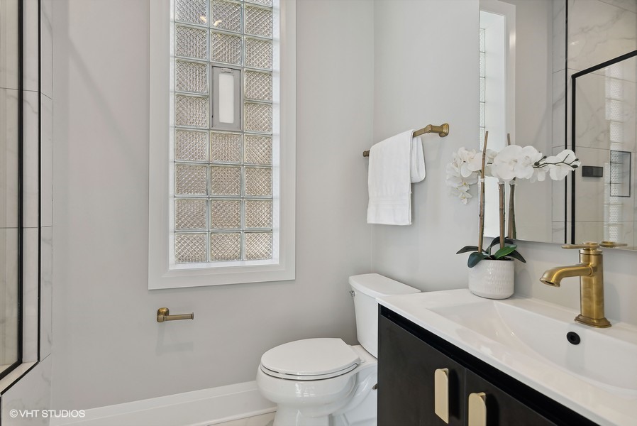 2139 West Crystal Street, Unit 1 Chicago, IL 60622 - Photo 15 of 27 a bathroom with a sink toilet and vanity