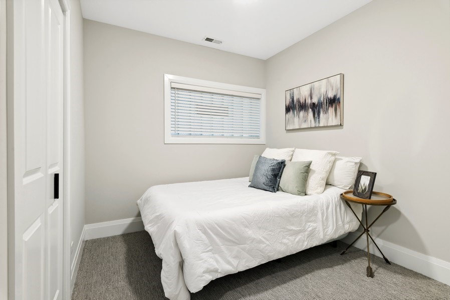 2139 West Crystal Street, Unit 1 Chicago, IL 60622 - Photo 22 of 27 a bedroom with a bed and a painting on the wall