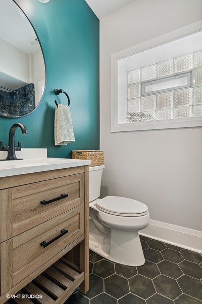 2139 West Crystal Street, Unit 1 Chicago, IL 60622 - Photo 23 of 27 a bathroom with a sink toilet and mirror