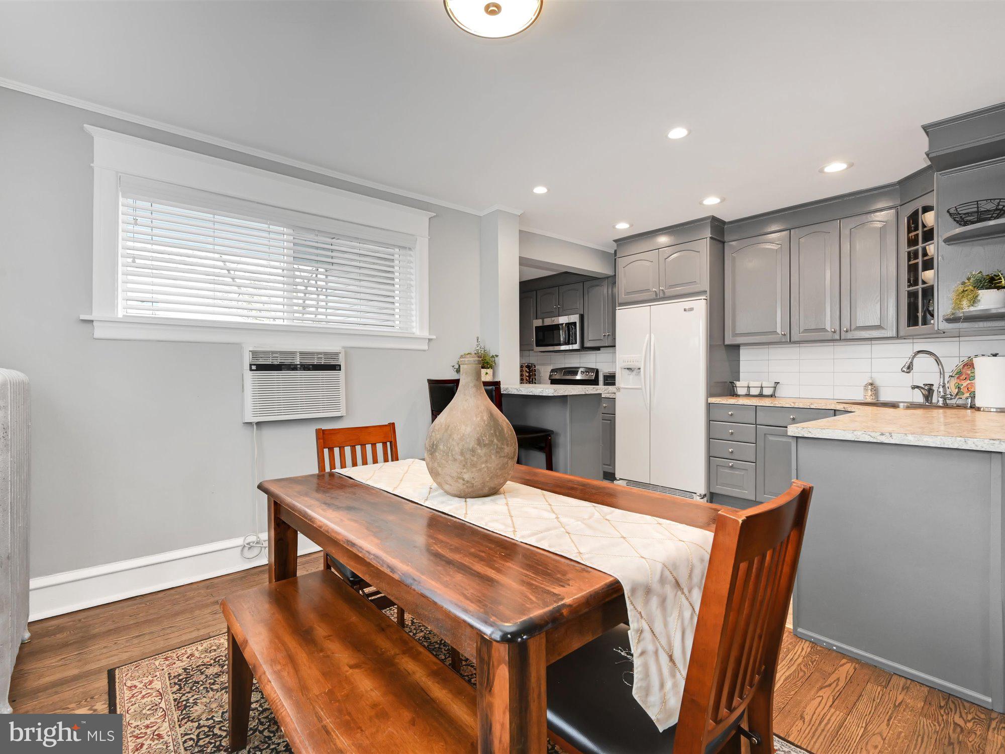 114 Summit Road Media, PA 19063 - Photo 7 of 27 a kitchen with kitchen island a stove a sink a refrigerator dining table and chairs