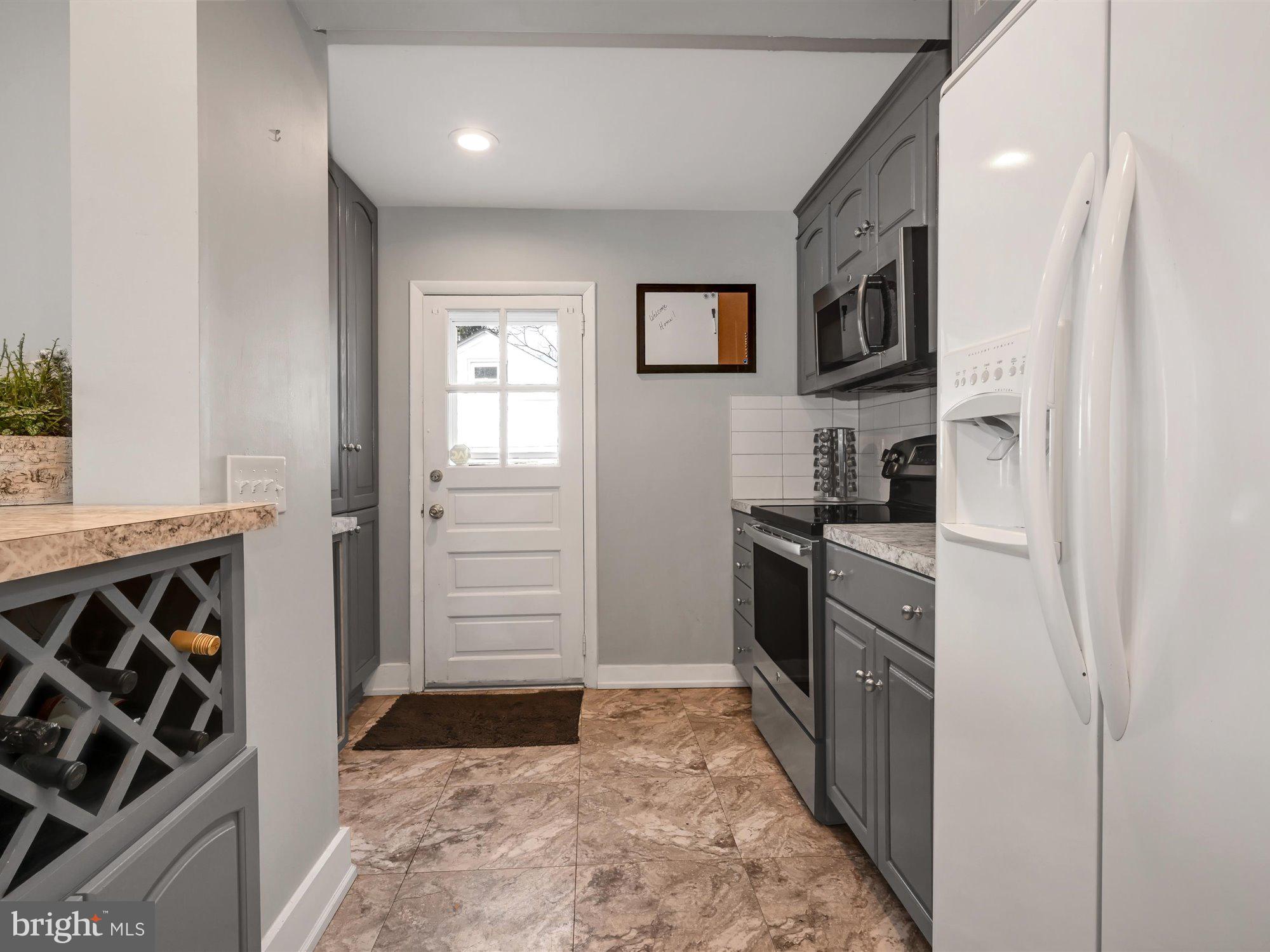 114 Summit Road Media, PA 19063 - Photo 10 of 27 a kitchen with a refrigerator and a stove