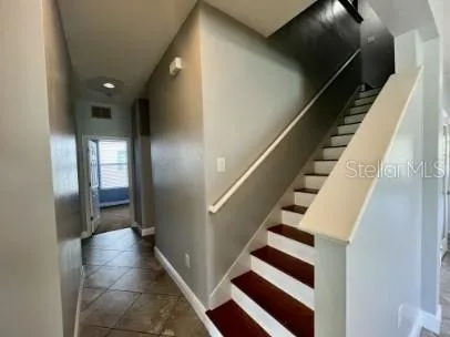 a view of entryway and hall with wooden floor