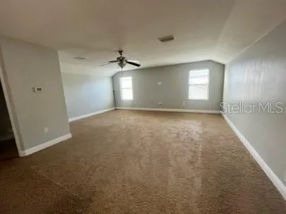 an empty room with windows and closet
