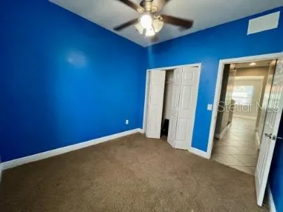a view of an empty room with a fan