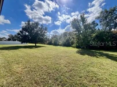 a view of yard with swimming pool and green space