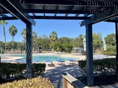 a view of a porch with a floor to ceiling window next to a yard