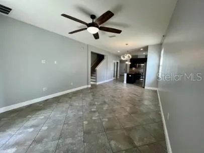 a view of a livingroom with a ceiling fan and wooden floor