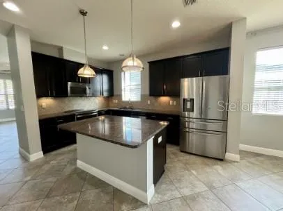 a kitchen with a refrigerator a sink and a stove
