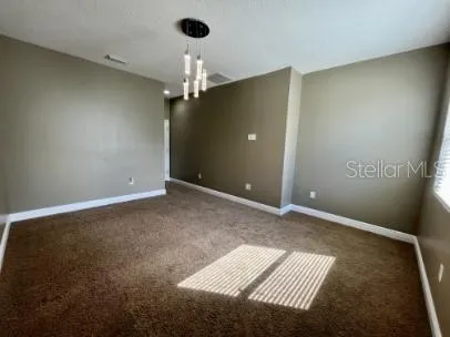 an empty room with a ceiling fan and a window