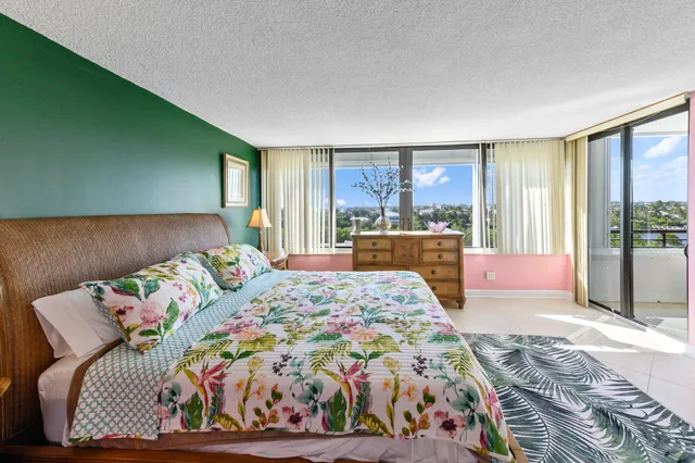 a bedroom with a bed and a large window