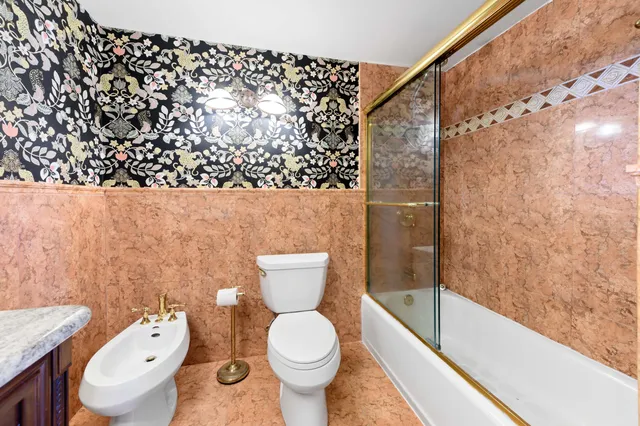 a bathroom with a toilet and a shower