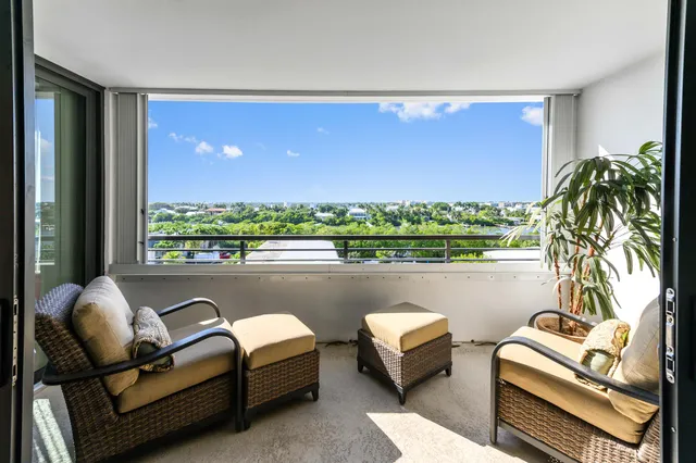 a living room with furniture and a floor to ceiling window