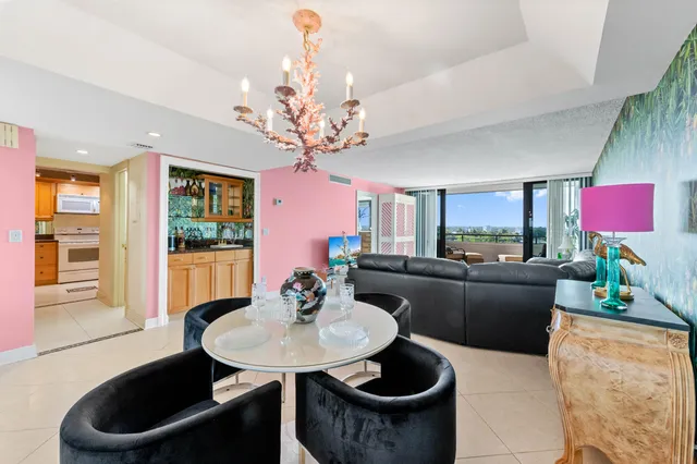 a living room with furniture a chandelier and a dining room