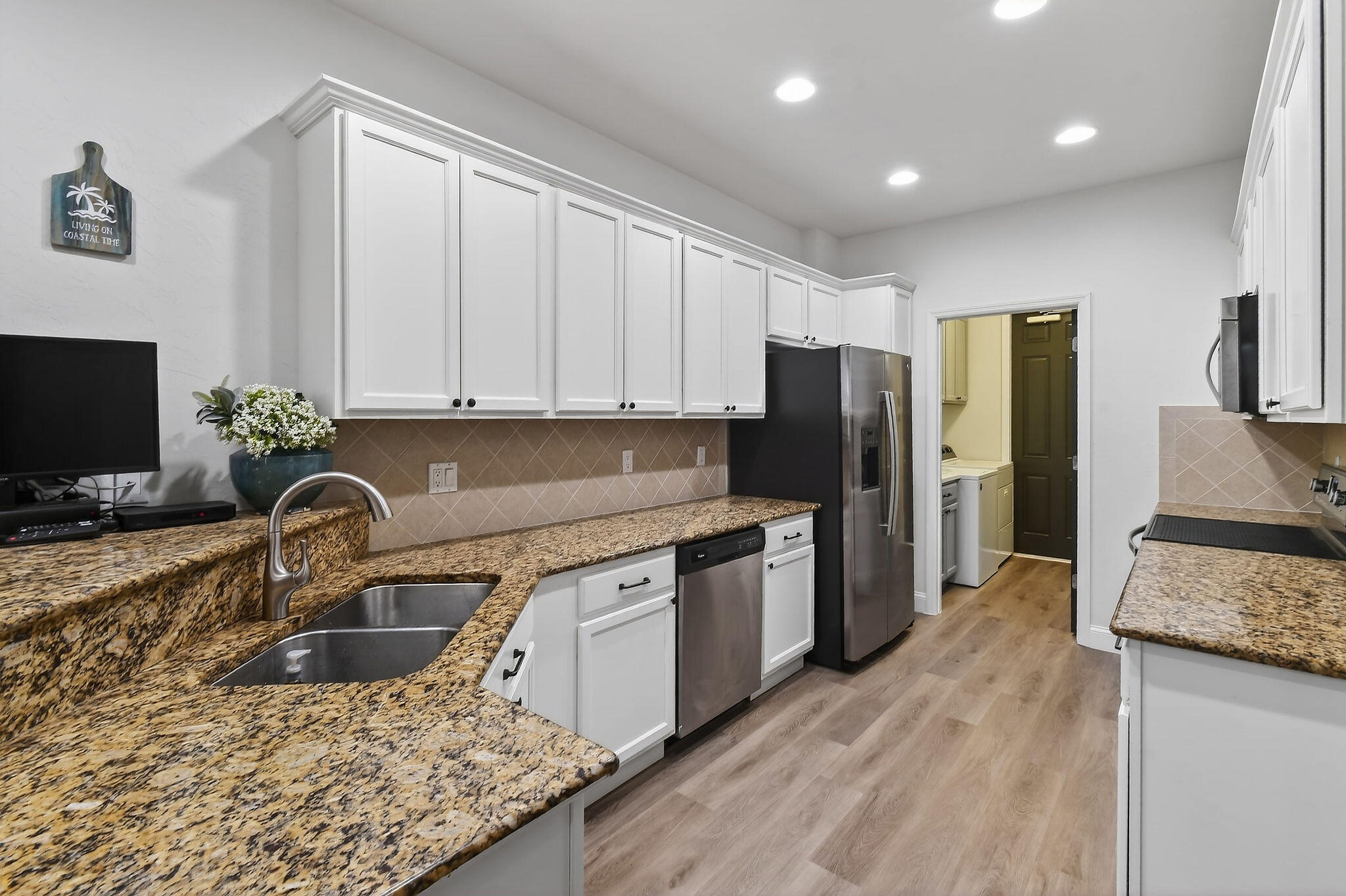 3241 Hemingway Drive Jupiter, FL 33458 - Photo 13 of 39 a kitchen with stainless steel appliances granite countertop a sink stove and refrigerator