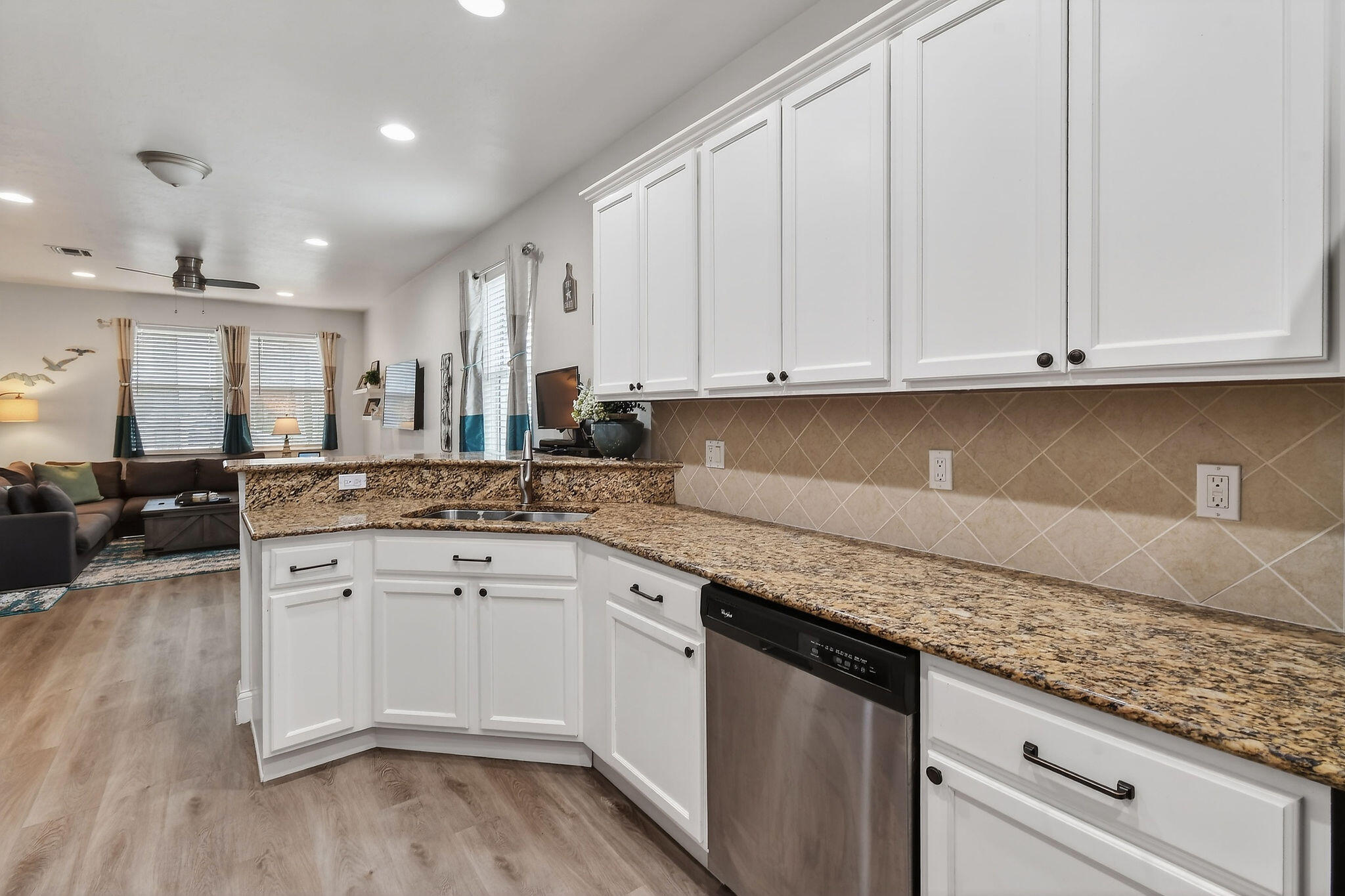 3241 Hemingway Drive Jupiter, FL 33458 - Photo 14 of 39 a kitchen with granite countertop white cabinets and white appliances