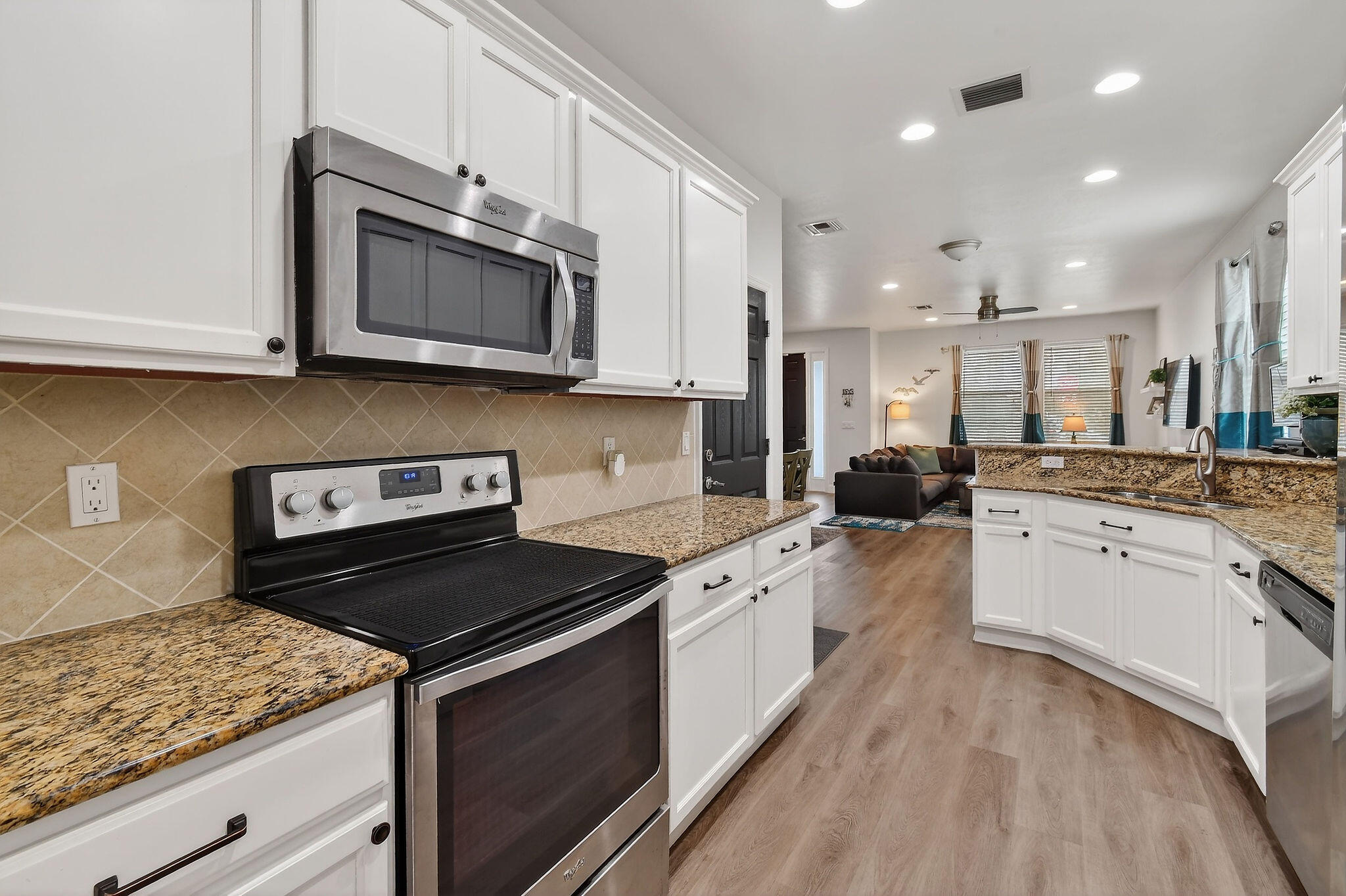 3241 Hemingway Drive Jupiter, FL 33458 - Photo 15 of 39 a kitchen with stainless steel appliances granite countertop a stove a sink and a microwave