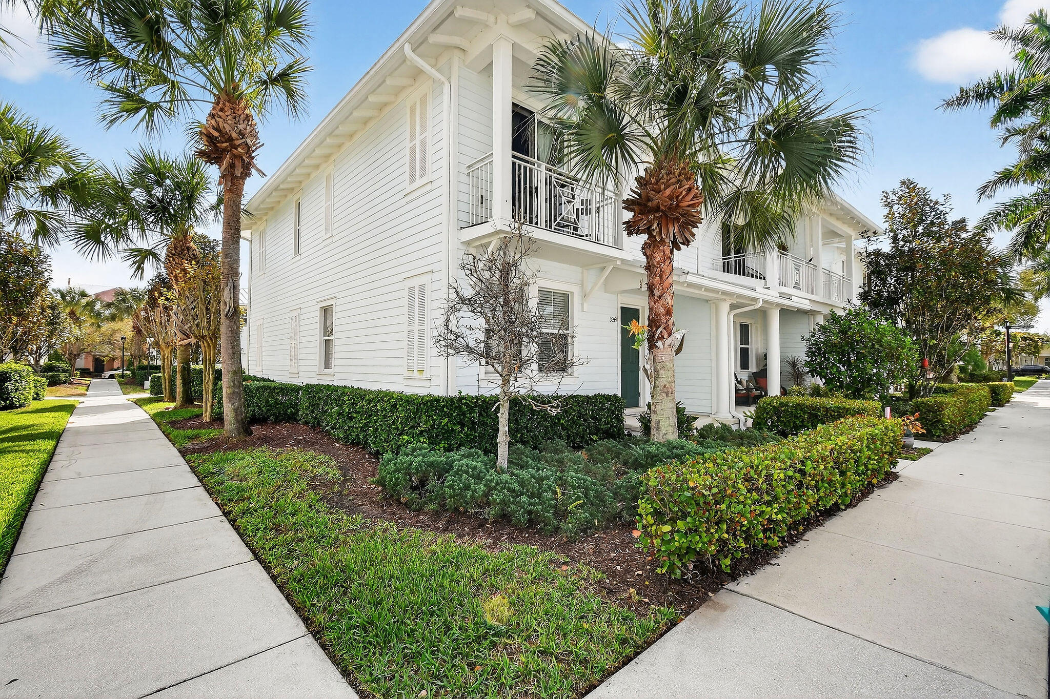 3241 Hemingway Drive Jupiter, FL 33458 - Photo 2 of 39 a front view of a house with a yard and trees