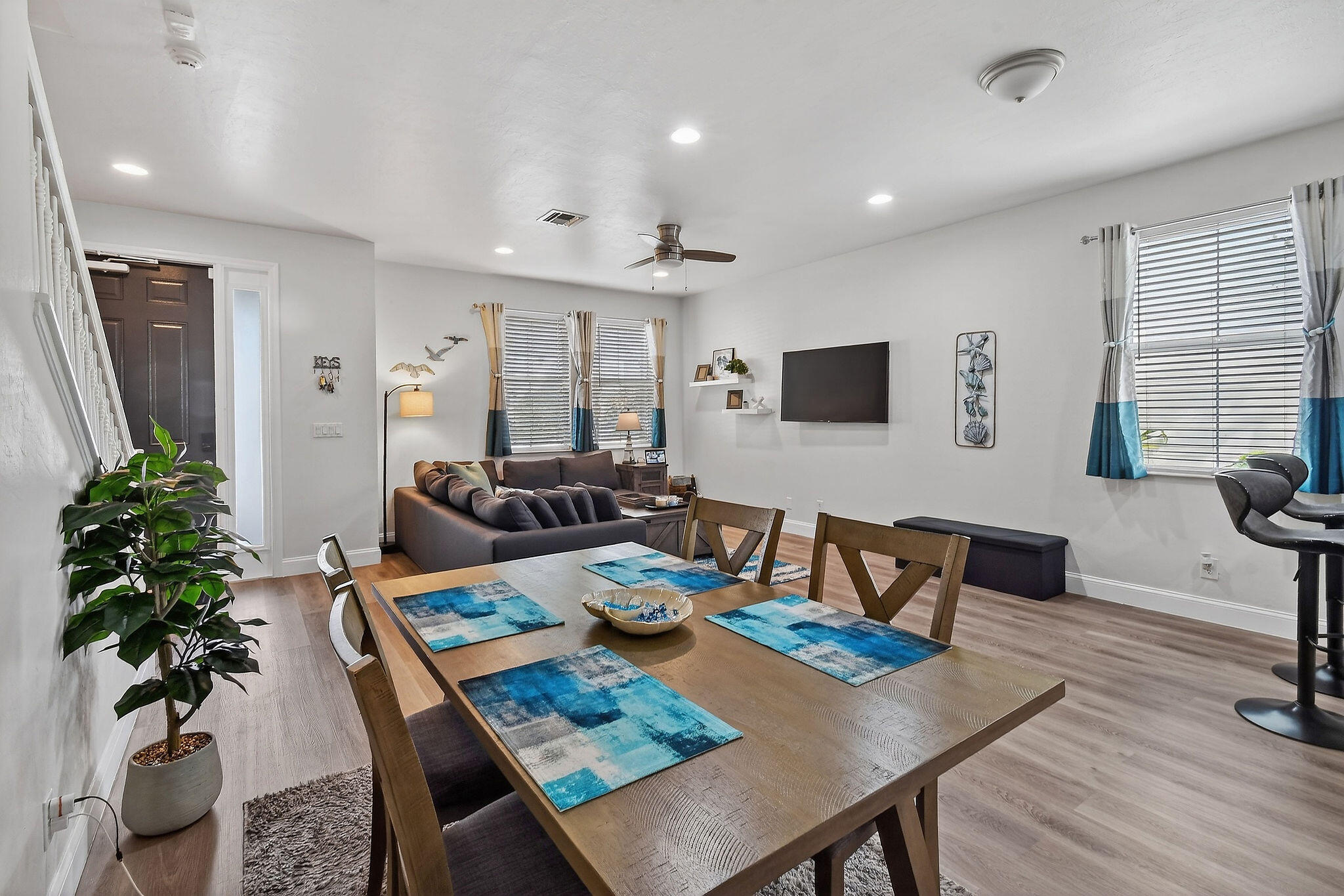 3241 Hemingway Drive Jupiter, FL 33458 - Photo 10 of 39 a living room with furniture potted plant a flat screen tv and a window