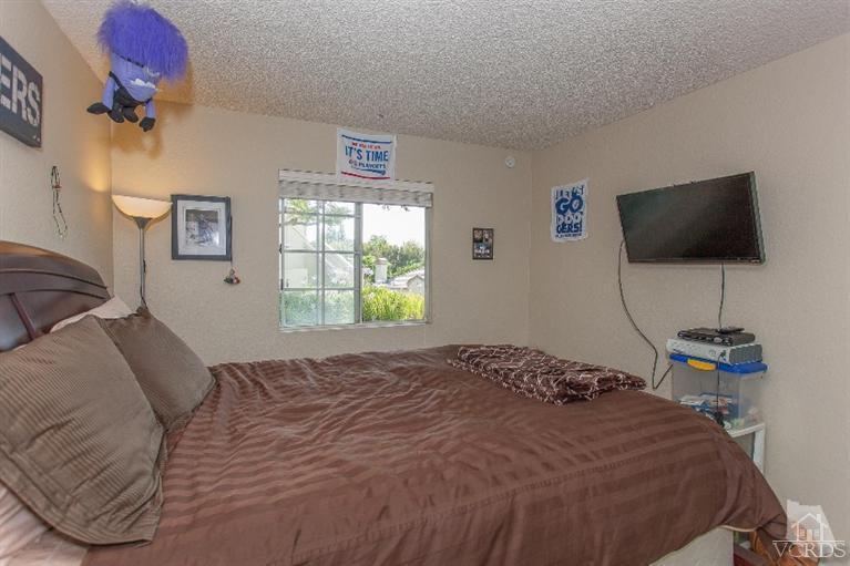 1235 Fitzgerald Road, Unit C Simi Valley, CA 93065 - Photo 14 of 28 a bedroom with a bed and a flat screen tv