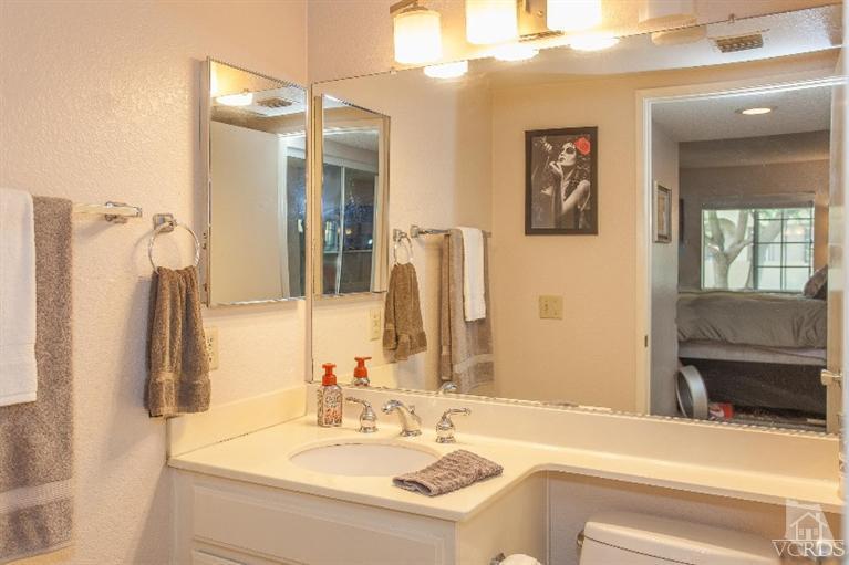 1235 Fitzgerald Road, Unit C Simi Valley, CA 93065 - Photo 22 of 28 a bathroom with a sink vanity and a mirror