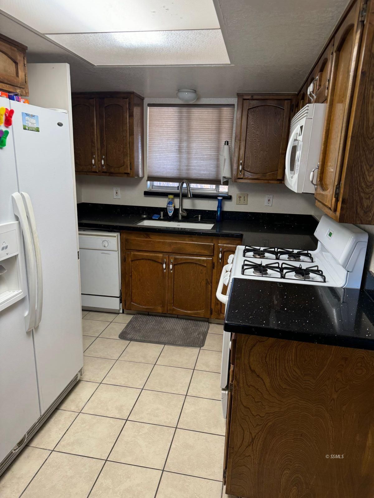 1505 South Farragut Street Ridgecrest, CA 93555 - Photo 5 of 12 a kitchen with a stove a refrigerator and a sink