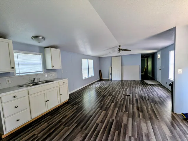 a view of a kitchen counter space a stove and cabinets