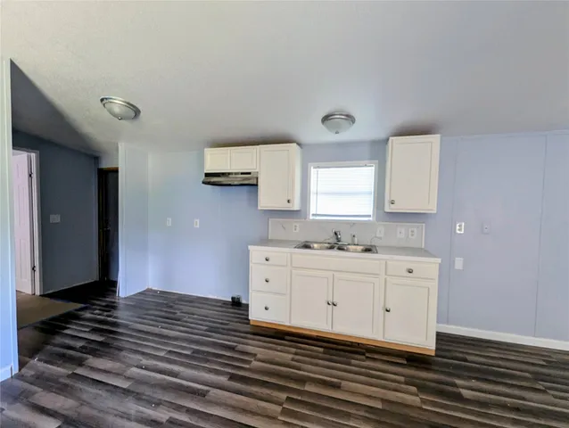 a bedroom with a bed and a flat tv screen on the dresser