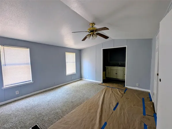a bathroom with a granite countertop sink a toilet and bathtub